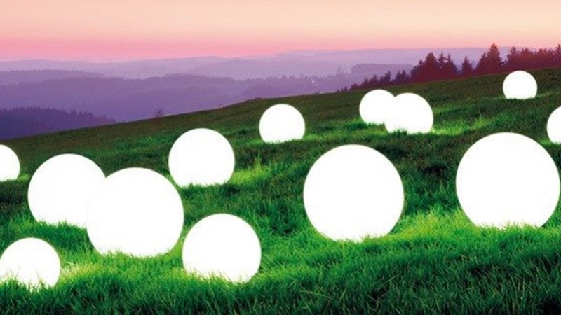 Spheres of light land in the garden